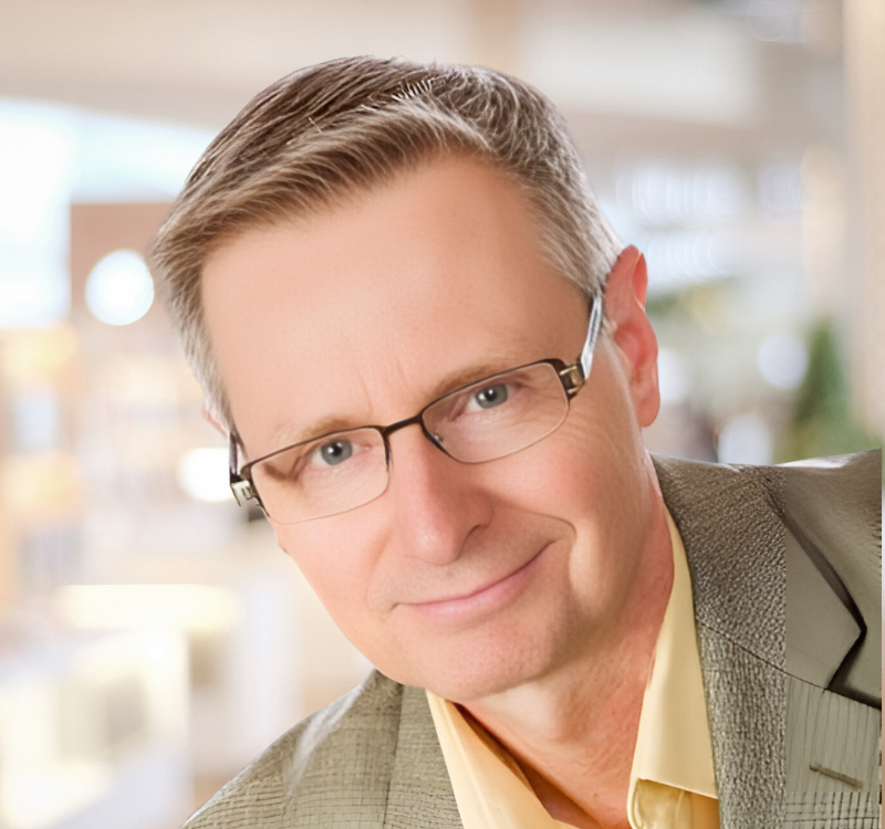 Ken Steven in yellow shirt and taupe jacket